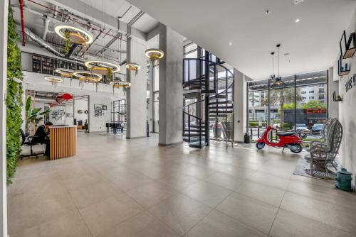 an empty lobby with a scooter in a building at Waves - Stylish Blue Haven near Town Square Park in Dubai