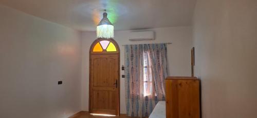 a room with a door and a stained glass window at Darna 3 in Asilah