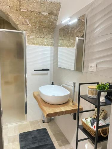 a bathroom with a white sink and a shower at LA MAISON Di FILOMENA in Aradeo