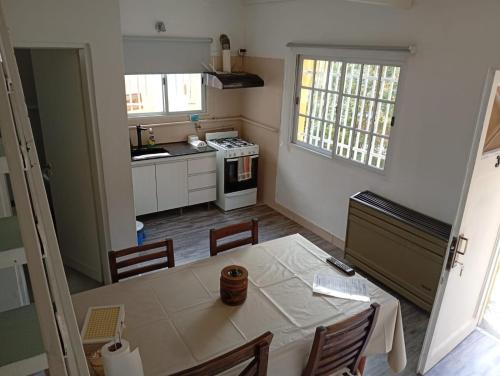 a kitchen with a table and a kitchen with a stove at Apart Vital 3 in El Calafate
