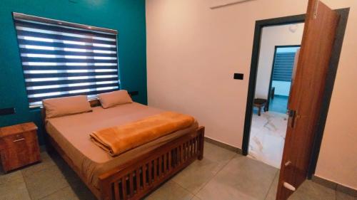 Una cama o camas en una habitación de Rambos Inn Homestay