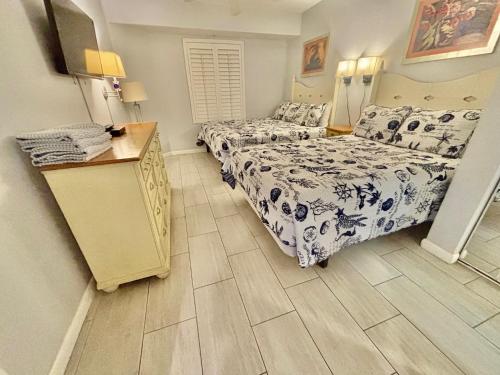 a bedroom with two beds and a wooden floor at Ocean Walk Resort - Spectacular Ocean Front View in Daytona Beach