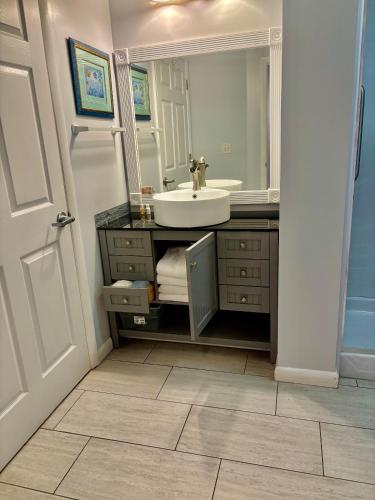 a bathroom with a sink and a mirror at Ocean Walk Resort - Spectacular Ocean Front View in Daytona Beach