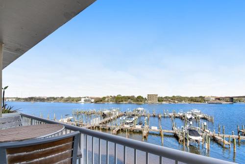 a view of a dock with boats in the water at Palm Court Yacht Club #303 in Fort Walton Beach