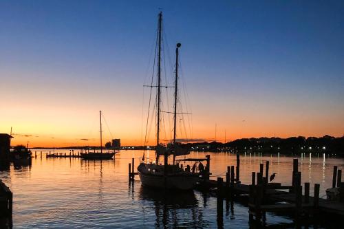 a boat docked at a dock in the water at Palm Court Yacht Club #303 in Fort Walton Beach
