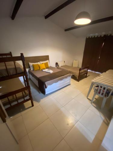a bedroom with two bunk beds and a couch at Vale do Pontal Angra Suites in Angra dos Reis