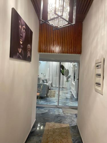 a hallway with a living room with a ceiling at Hôtel Saphir Group in Douala