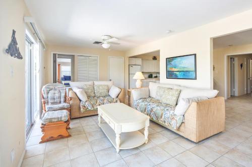 a living room with two couches and a table at Lobster Lodge in Duck Key