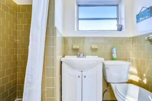 a bathroom with a sink and a toilet and a window at Fisherman's Bungalow in Conch Key