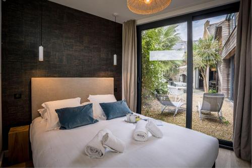 a bedroom with a large bed with towels on it at La villa du port perros guirec piscine billard in Perros-Guirec