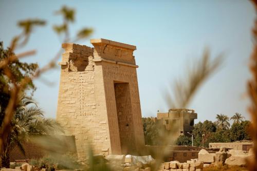 a tall brick building in front of a castle at White Gorf Hotel in Luxor