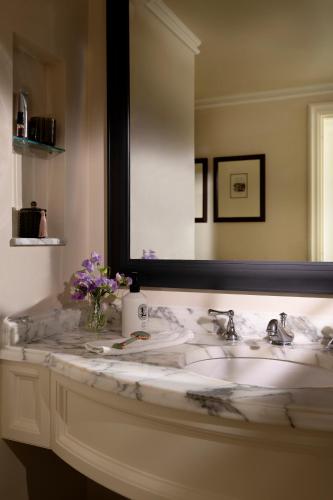 a bathroom with a white sink and a mirror at The Langham Huntington, Pasadena in Pasadena