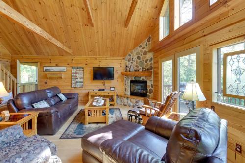 a living room with leather furniture in a cabin at Lakefront Hazelhurst Cabin Dock and Pool Table in Hazelhurst