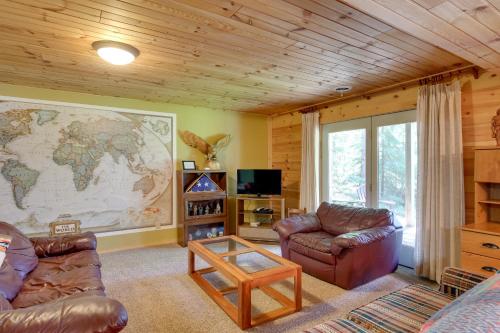 a living room with a map of the world on the wall at Lakefront Hazelhurst Cabin Dock and Pool Table in Hazelhurst