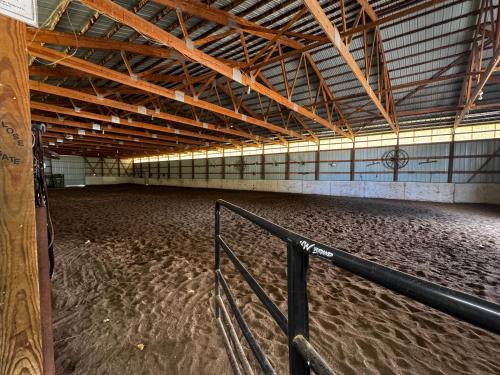 an empty arena with a horse stalls in it at The Bar R Ranch LLC in Idaho Falls