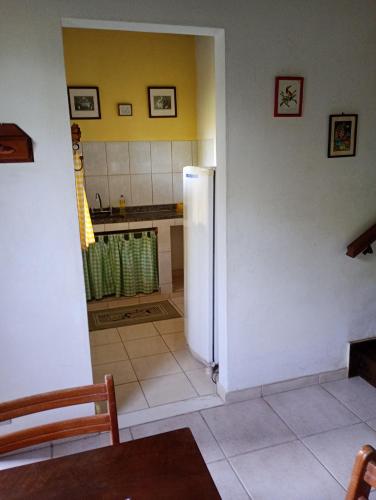 a kitchen with a white refrigerator in a room at Pousada Arboretum in Penedo