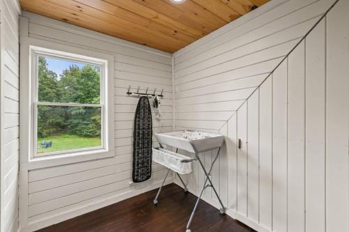 a white room with a sink and a window at Red River Gorge Family Cabin with Hot Tub in Rogers