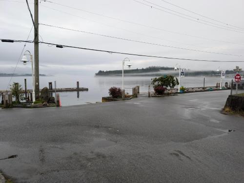 an empty parking lot next to a body of water at Gordie's Inn & Suites in Alert Bay