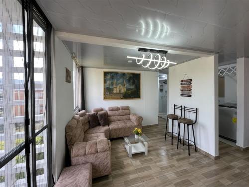 a living room with a couch and a table at Apartamento en Guaduas 2 habitaciones 4 camas in Guaduas