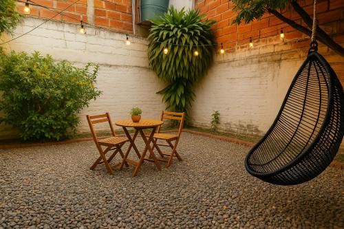 a patio with a table and two chairs and a hammock at Ana home in Neiva