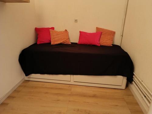 a bed with two pillows on it in a room at Beautiful apartment with direct beach access in Sète