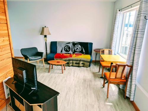 a living room with a couch and a table at Gordie's Inn & Suites in Alert Bay