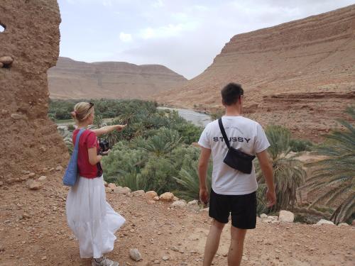 a man and a woman looking at a canyon at Gîte Palma Eagle Ziz Canyon in Er Rachidia