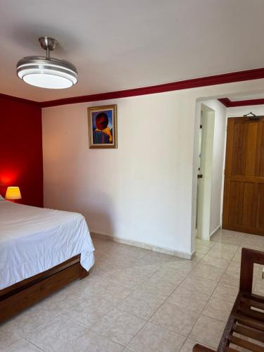 a bedroom with a bed and a painting on the wall at LUTIX HOTELS in El Limón
