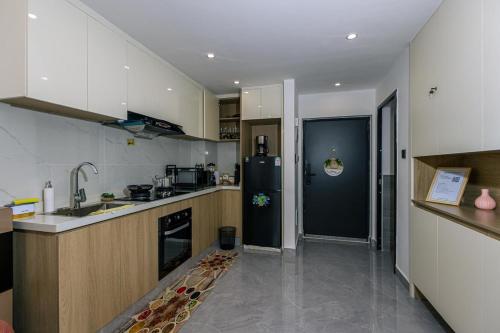a kitchen with a sink and a refrigerator at Serene stays by Remi in Nairobi