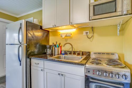 a kitchen with a sink and a white refrigerator at Fisherman's Hideaway in Conch Key