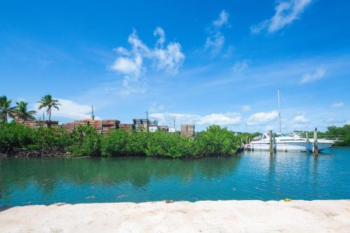 a boat is docked in the water next to a beach at Fisherman's Hideaway in Conch Key