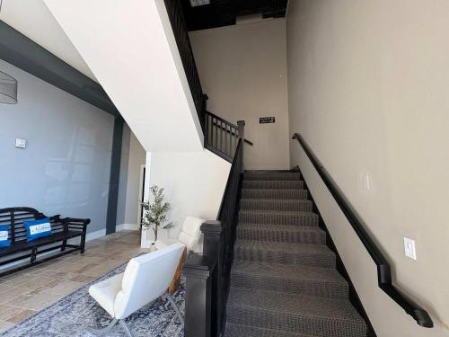 a stairway with a white couch and a white chair at Boutique Hotel Room 8 in Northport