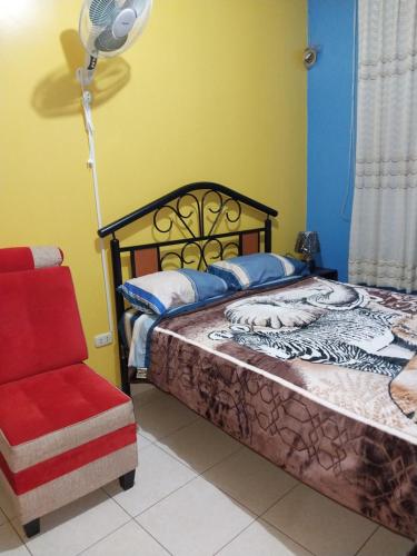 a bedroom with a bed and a chair at Piso de 2 camas in Moyobamba