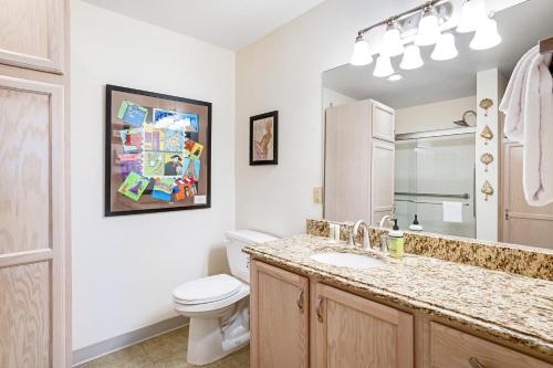 a bathroom with a sink and a toilet and a mirror at Sandside in Long Beach