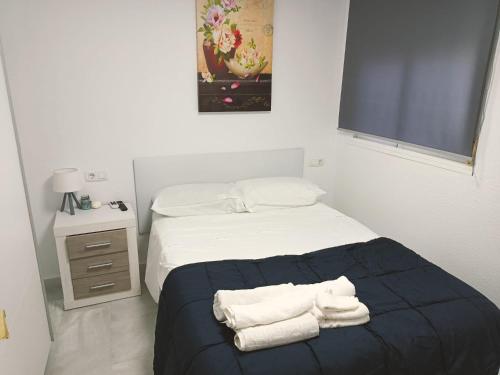 En eller flere senge i et værelse på Ático Cassinello Roquetas