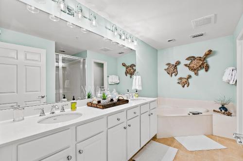 a bathroom with a sink and a large mirror at The Preserve 202 in Blue Mountain Beach