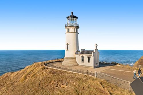 a lighthouse on a cliff next to the ocean at Boardwalk Adventures in Long Beach