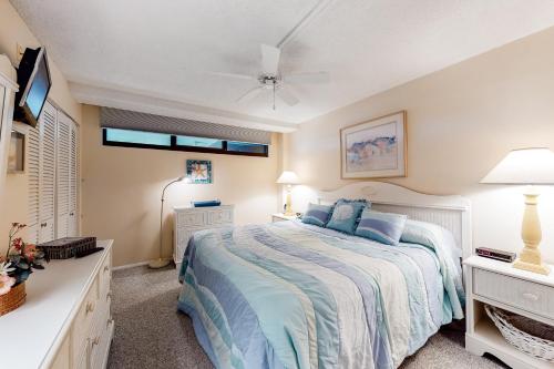 a bedroom with a bed and a ceiling fan at Sea Colony - 109 Chesapeake House Rd in Sea Colony