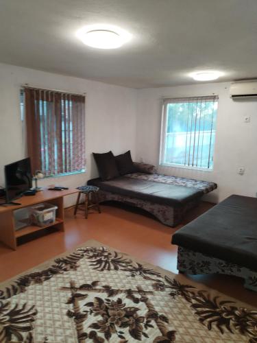 a living room with a couch and a table at Вила "до Гората" in Zărkwischte