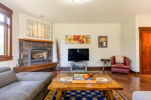a living room with a couch and a table at The Historic 901 Condos In the Heart of Fernie in Fernie