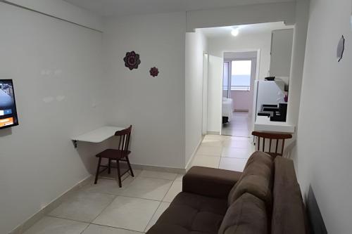 a living room with a couch and a table at Apartamento praia Natal in Natal