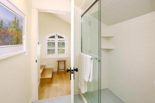 a bathroom with a shower and a glass door at Riverhouse in Capitola