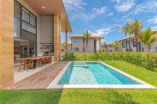 a swimming pool in the backyard of a house at JG Flecheiras in Trairi
