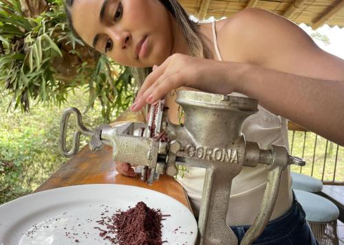 a woman is standing next to a mixer with chocolate cake at MuchoSur Filandia in Filandia