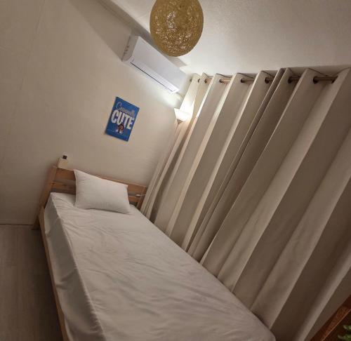 a bed in a room with curtains and a sign at 블레싱하우스 in Seoul