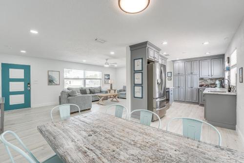a kitchen and living room with a table and chairs at 4 Mi to Beaches Seminole Charmer with Outdoor Oasis in Seminole