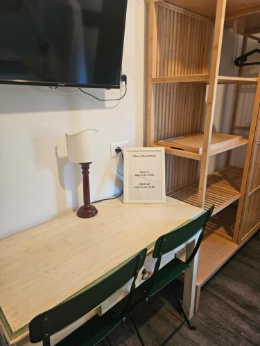 a table with a tv on top of it at VILLA VILLACOLLE in Procchio