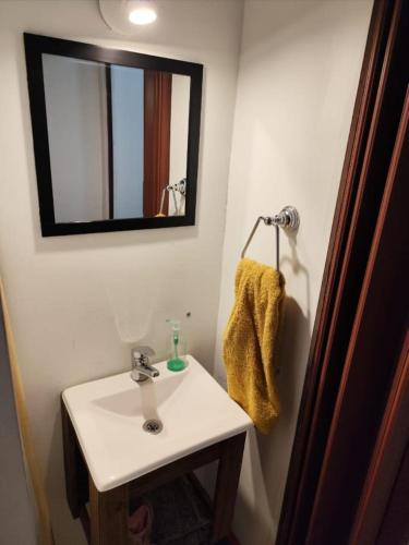 a bathroom with a white sink and a mirror at Alta Montaña in Potrerillos