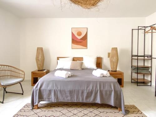 a bedroom with a bed with two towels on it at Villa Cameo in Le Gosier