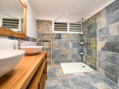 a bathroom with a sink and a toilet in it at Villa Cameo in Le Gosier